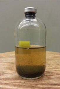 Bottle with brown liquid inside